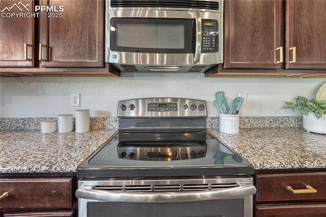 kitchen with stainless steel appliances, stone counters, and dark brown cabinetry