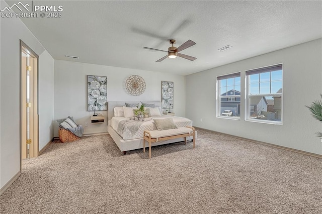 carpeted bedroom with a ceiling fan, baseboards, visible vents, and a textured ceiling