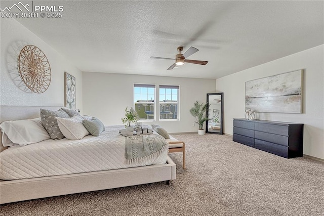 bedroom with a textured ceiling, carpet, a ceiling fan, and baseboards