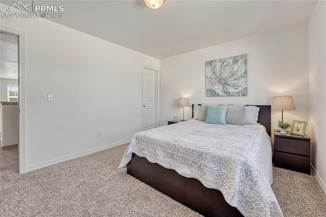 carpeted bedroom featuring baseboards