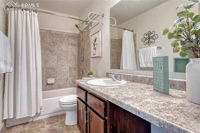 full bath featuring shower / bath combo, vanity, and toilet