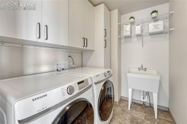 laundry area featuring cabinet space, washing machine and dryer, and baseboards