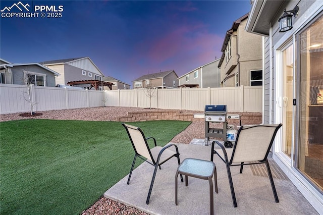 view of patio with a fenced backyard, a residential view, and grilling area