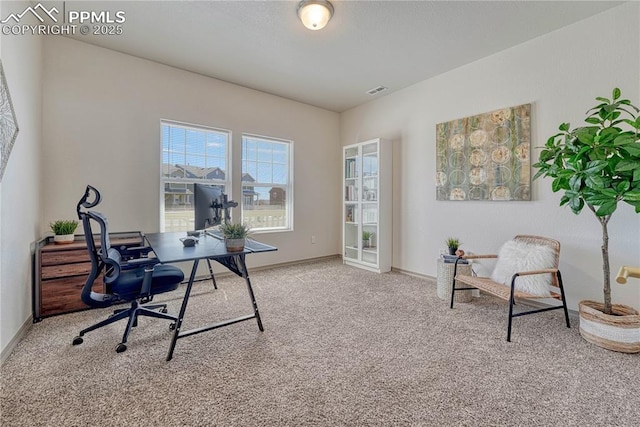 carpeted home office with baseboards