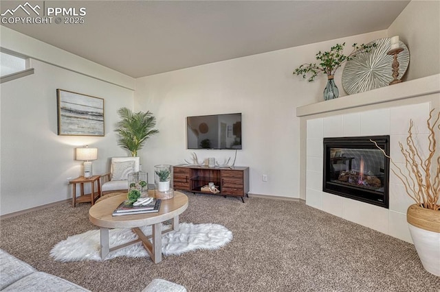 carpeted living room with a fireplace and baseboards