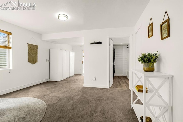 unfurnished bedroom featuring a closet, baseboards, and carpet flooring