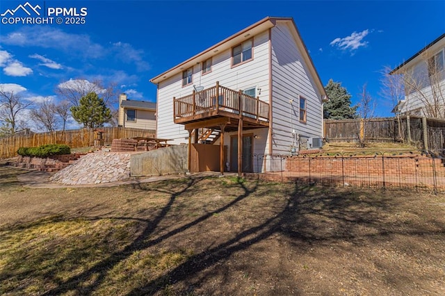 rear view of property with a fenced backyard, a patio, a deck, and stairs