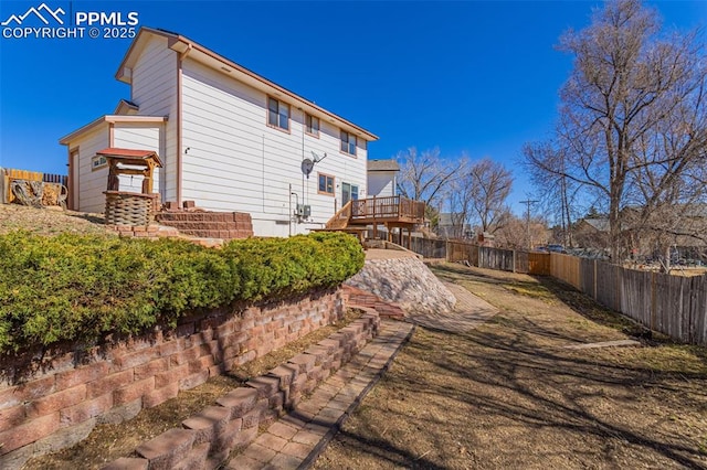 back of house featuring a fenced backyard and a wooden deck