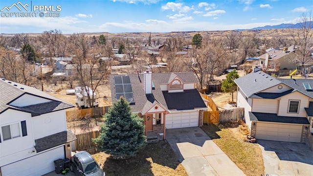 drone / aerial view with a residential view and a mountain view