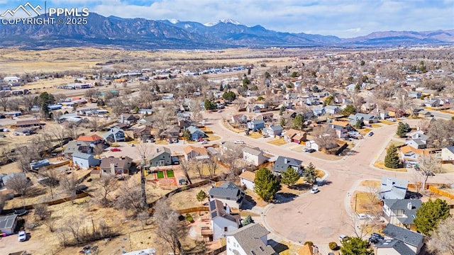 drone / aerial view featuring a residential view and a mountain view