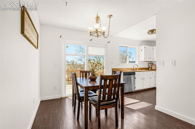 dining space featuring dark wood-type flooring, a textured ceiling, and baseboards