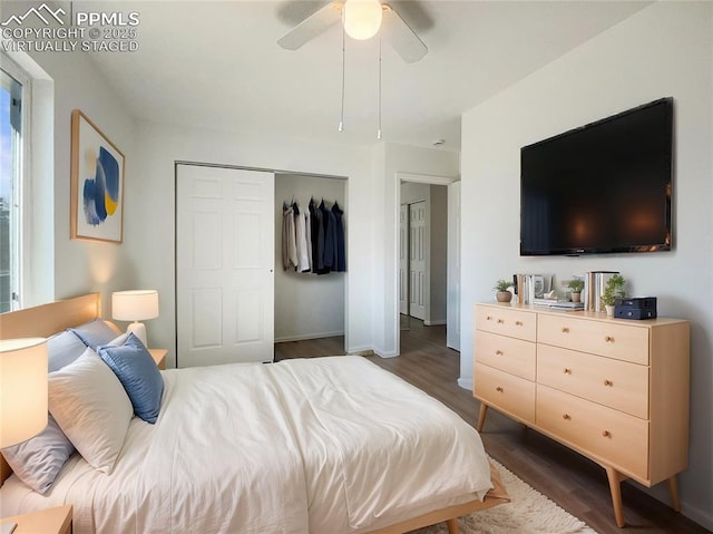 bedroom featuring a ceiling fan, a closet, baseboards, and wood finished floors