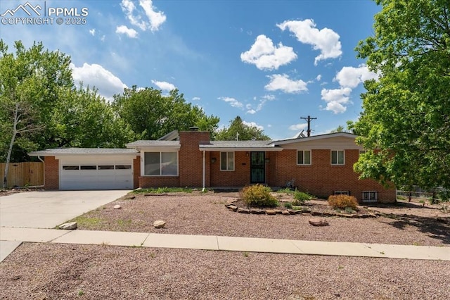 1328 Swope Ave, Colorado Springs, CO 80909 - ranch-style home featuring concrete driveway, brick siding, and a garage