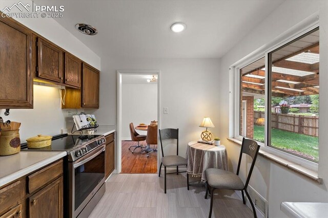 1328 Swope Ave, Colorado Springs, CO 80909 - kitchen featuring stainless steel electric range, light countertops, and baseboards