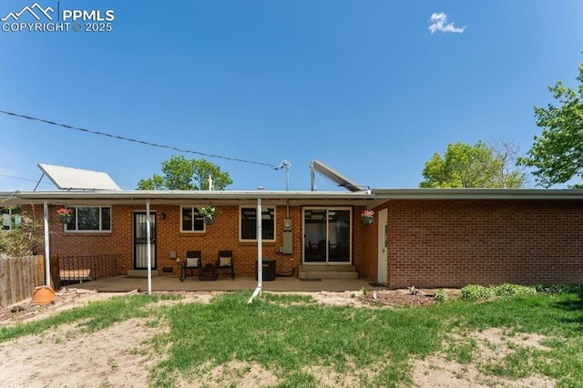 1328 Swope Ave, Colorado Springs, CO 80909 - rear view of property with a patio area, entry steps, brick siding, and central AC unit