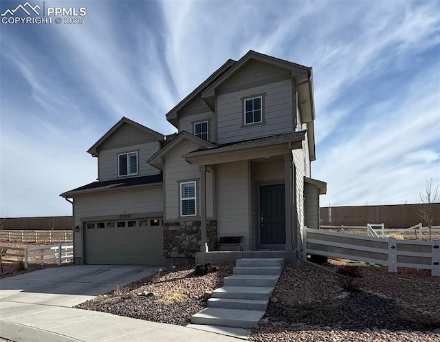 traditional-style home featuring concrete driveway, an attached garage, and fence