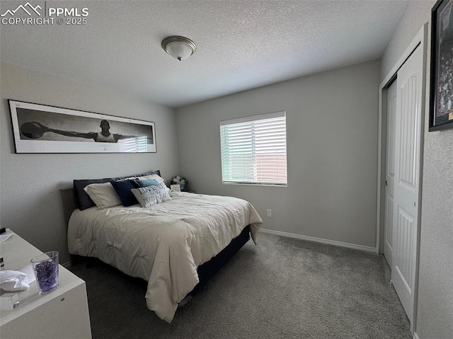 carpeted bedroom featuring a closet, a textured ceiling, and baseboards