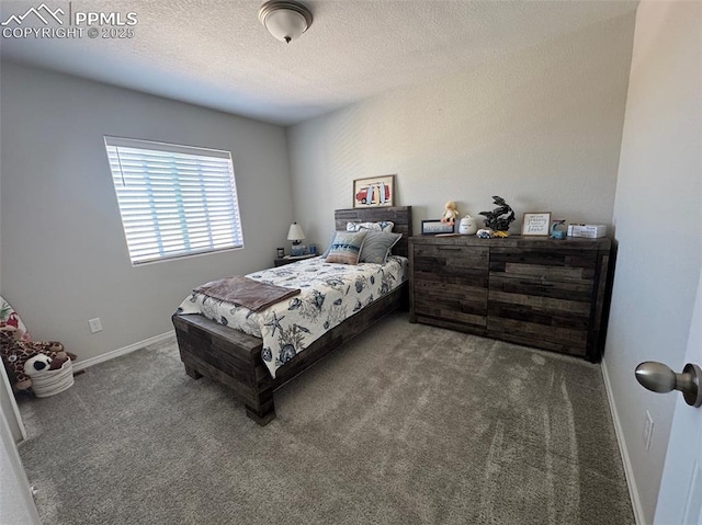 carpeted bedroom with a textured ceiling and baseboards