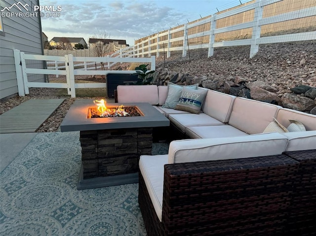 view of patio featuring a fenced backyard and an outdoor living space with a fire pit