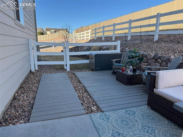 wooden terrace featuring a fenced backyard