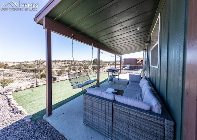 view of patio / terrace featuring outdoor lounge area and fence