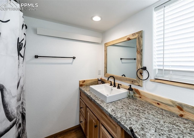 bathroom featuring recessed lighting and vanity