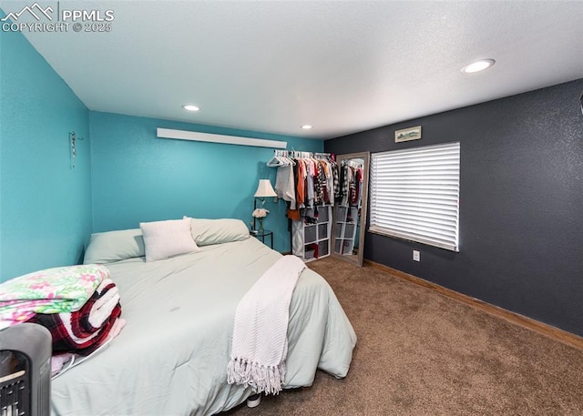 carpeted bedroom featuring recessed lighting and baseboards