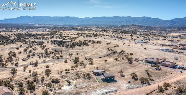 drone / aerial view featuring a rural view, a desert view, and a mountain view