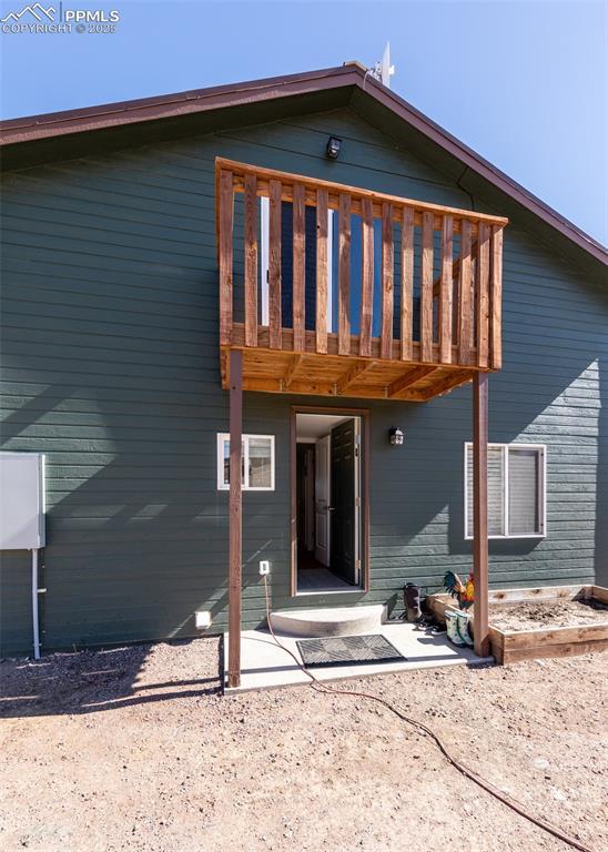 back of house with a wooden deck