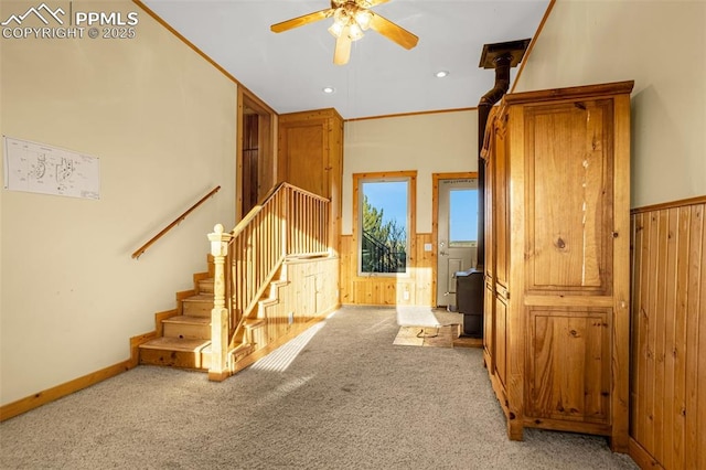 interior space with wooden walls, baseboards, ceiling fan, carpet flooring, and recessed lighting