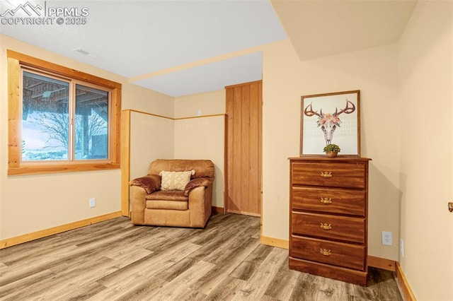 sitting room with wood finished floors and baseboards