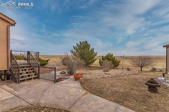 view of patio featuring a deck and stairway