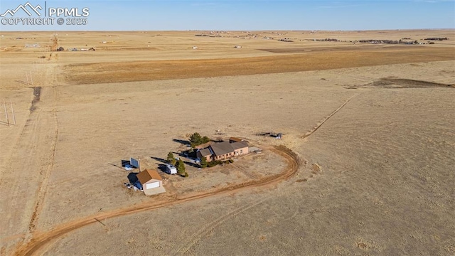 birds eye view of property featuring view of desert and a rural view