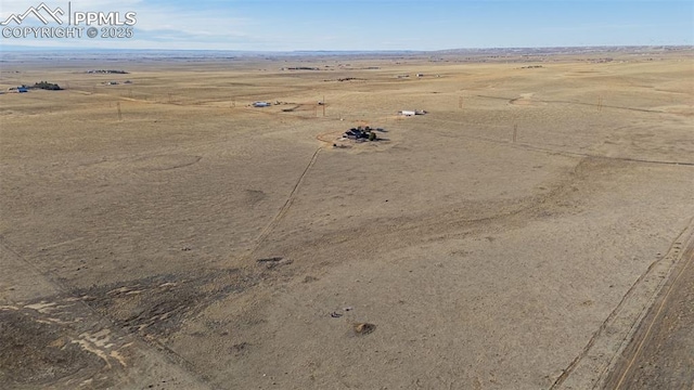 drone / aerial view with view of desert and a rural view