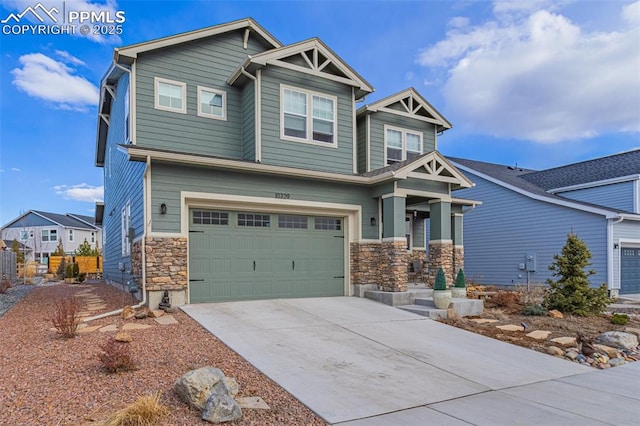 craftsman house with driveway, stone siding, and a garage