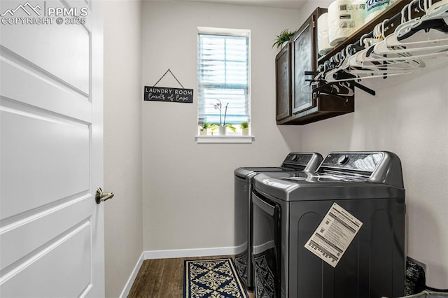 clothes washing area with cabinet space, independent washer and dryer, baseboards, and wood finished floors