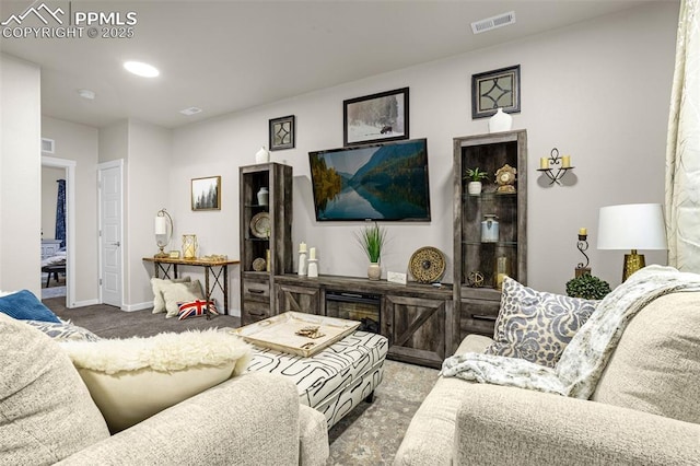 carpeted living area with recessed lighting, visible vents, and baseboards