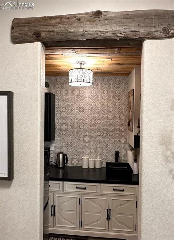 kitchen featuring dark countertops and white cabinets