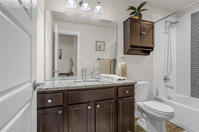 full bath with toilet, washtub / shower combination, and vanity