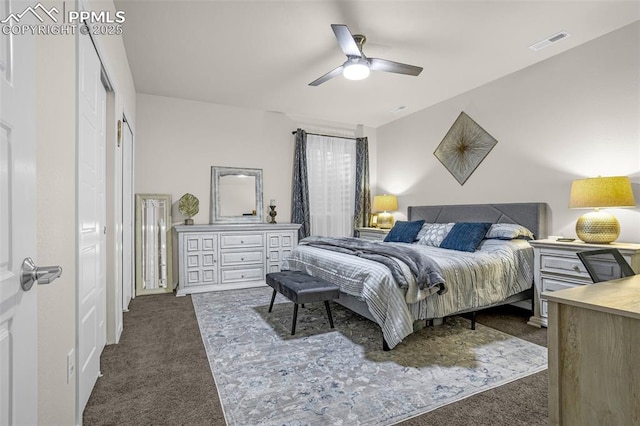 bedroom with dark colored carpet, visible vents, and a ceiling fan