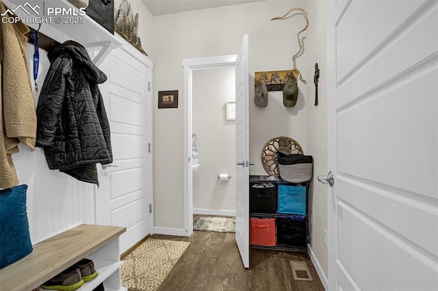 mudroom with baseboards, visible vents, and dark wood-style flooring