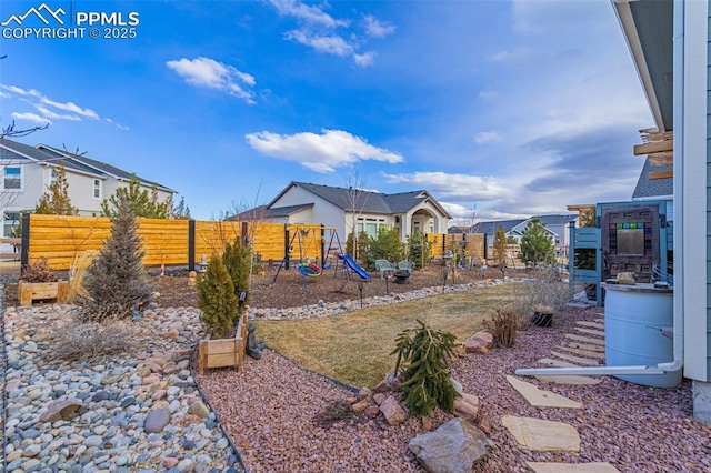 view of yard featuring fence and a playground