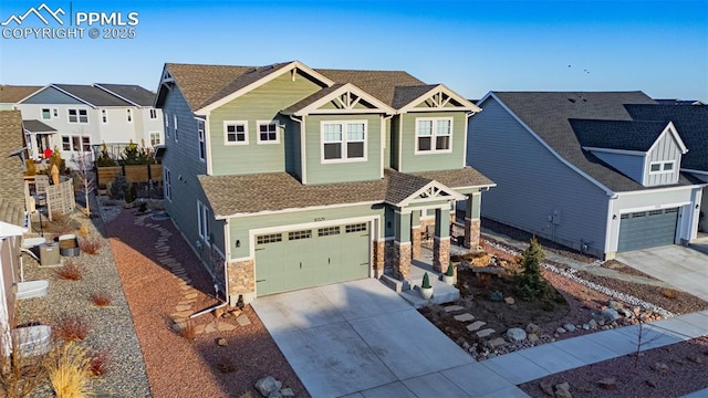 craftsman-style house with a residential view, stone siding, driveway, and an attached garage