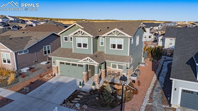 view of front of home featuring a shingled roof, a residential view, and concrete driveway