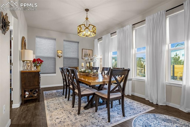 dining area with a notable chandelier, baseboards, and wood finished floors