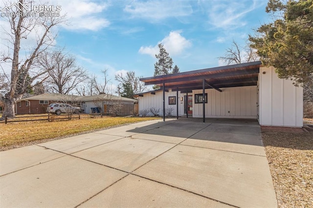 exterior space featuring a front yard, a carport, and driveway