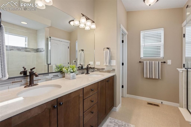 bathroom with visible vents, a sink, backsplash, and double vanity