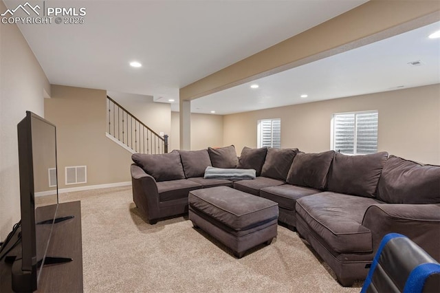 carpeted living area with recessed lighting, visible vents, baseboards, and stairs