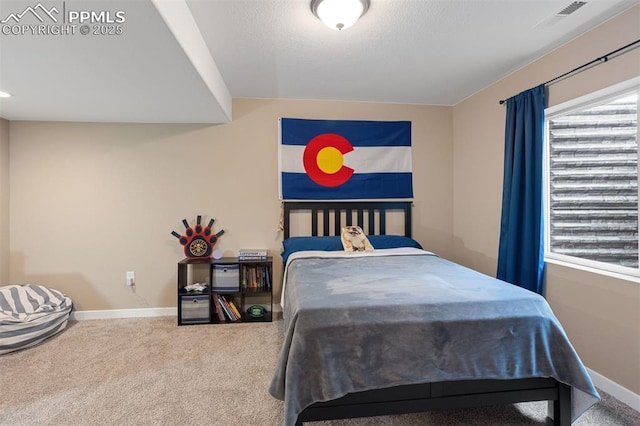 bedroom featuring carpet floors, baseboards, and visible vents