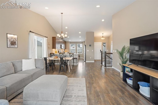 living area with dark wood-style floors, lofted ceiling, recessed lighting, a chandelier, and baseboards